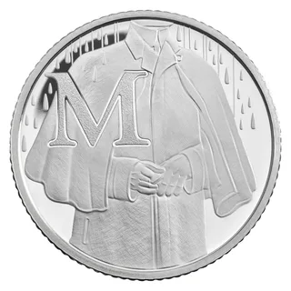 A figure in a long Mackintosh raincoat with hands clasped, rain falling, beside a large letter M