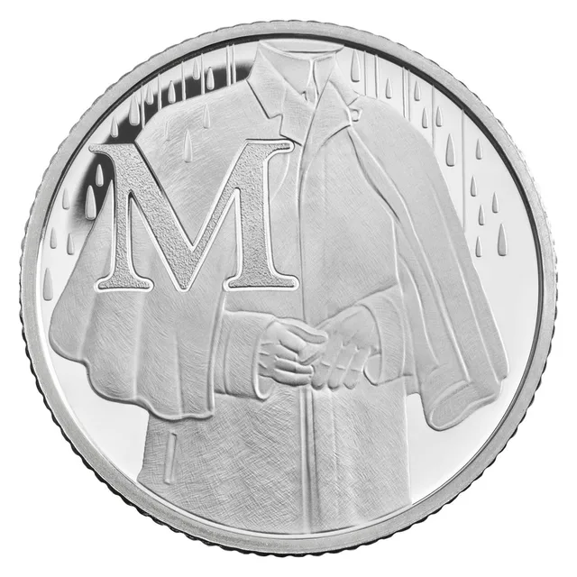 A figure in a long Mackintosh raincoat with hands clasped, rain falling, beside a large letter M