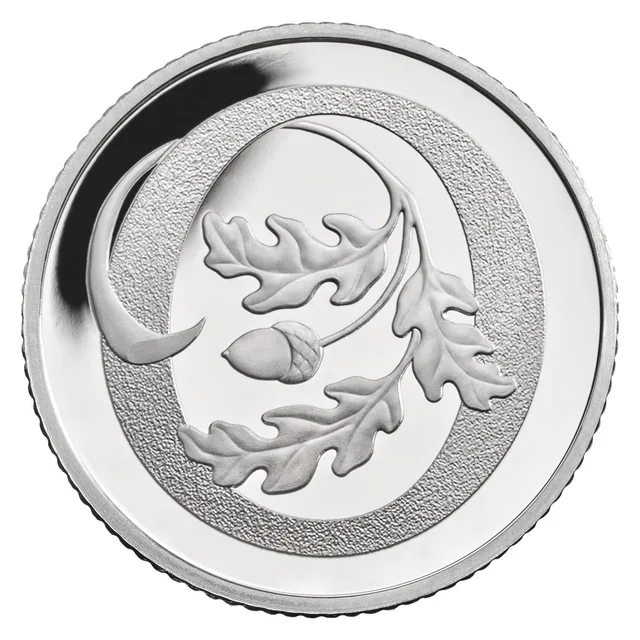 A sprig of oak leaves with an acorn curling across a large frosted letter O