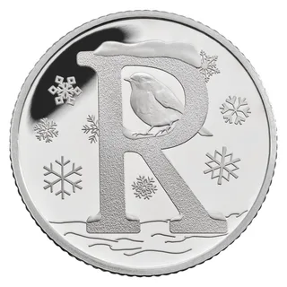 A robin perched inside a large letter R topped with snow, surrounded by snowflakes