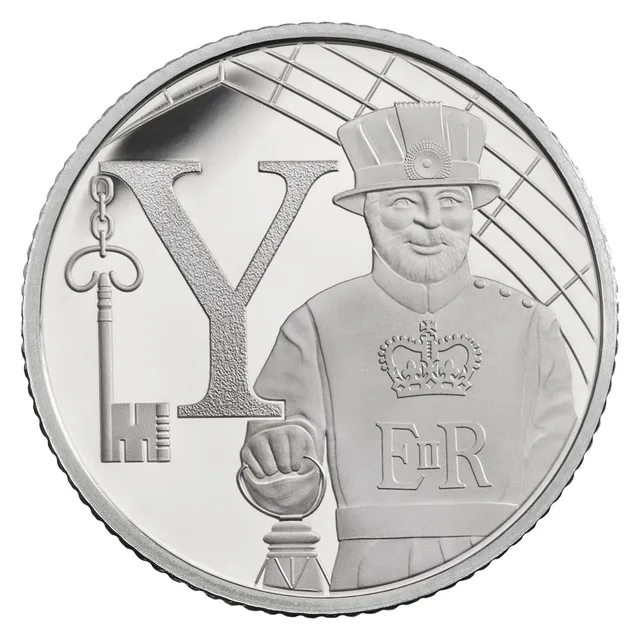 A Yeoman Warder beside a large capital letter Y with a key hanging from it, and the cypher E II R