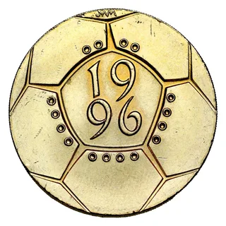 A stylised football of panels filling the coin, with the date in the centre ringed by sixteen small circles