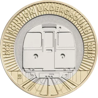 Front of a Victoria line Tube train emerging from a tunnel, with LONDON UNDERGROUND around the top between two dates