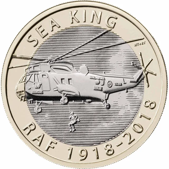 Sea King rescue helicopter flying left with a crewman on the winch line, SEA KING upper left and RAF 1918-2018 below
