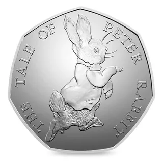 Peter Rabbit in his jacket walking to the right, with THE TALE OF PETER RABBIT running round the rim