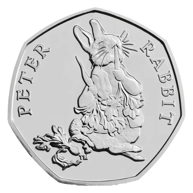Peter Rabbit facing forward in his jacket, eating, with PETER RABBIT around him and a small TM mark