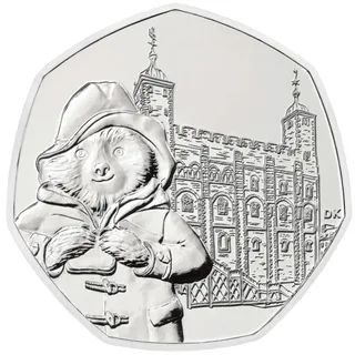 Paddington Bear holding a marmalade sandwich in front of the White Tower at the Tower of London