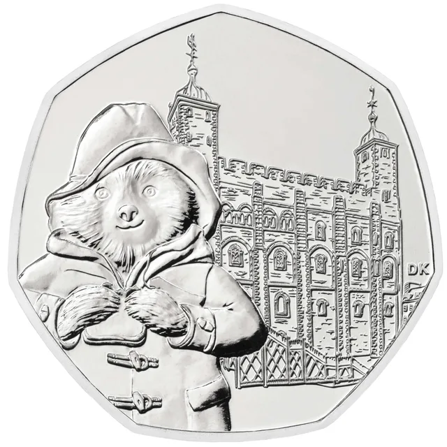 Paddington Bear holding a marmalade sandwich in front of the White Tower at the Tower of London