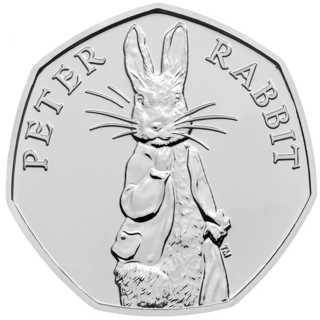 Front-facing Peter Rabbit in his trademark jacket, the name PETER RABBIT and a TM mark running round him