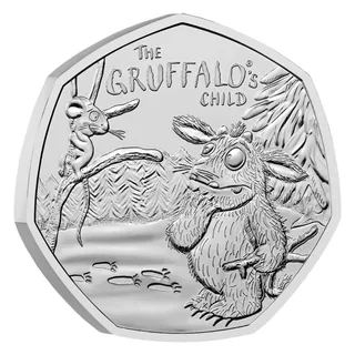 The Gruffalo's Child holding a Stick Man doll in the snow as the Mouse smirks from a tree