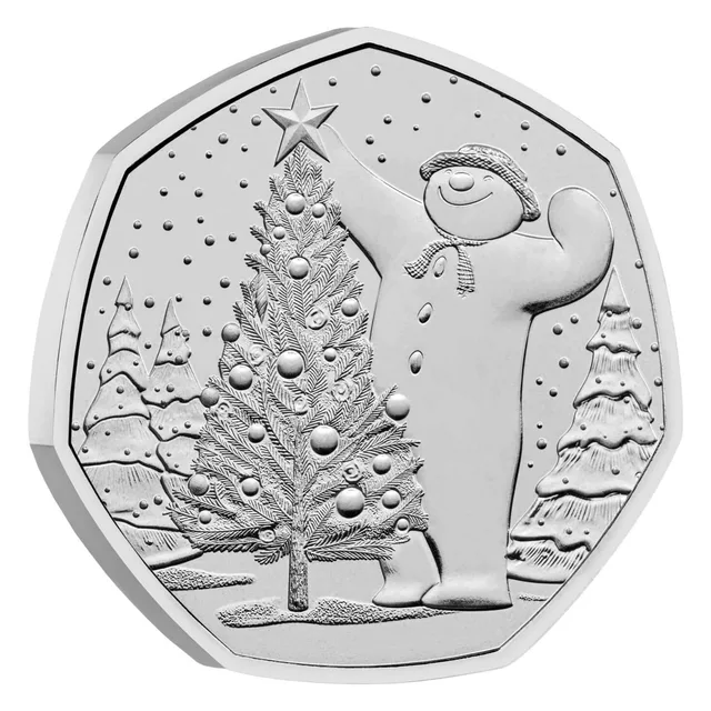 The Snowman placing a star on top of a Christmas tree, with more Christmas trees around him